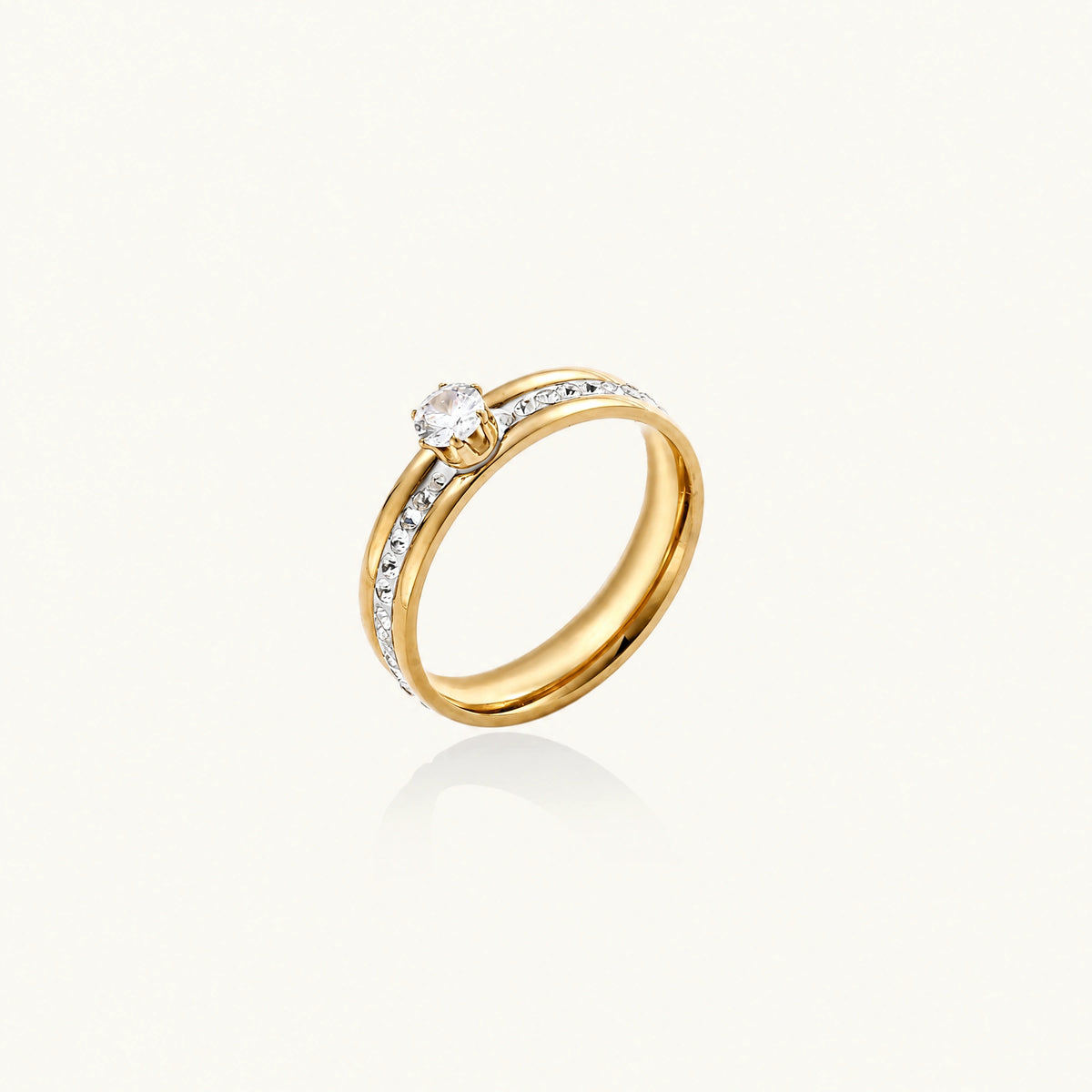 Gold-plated double-band ring with center rhinestone solitaire and channel-set stones on white background