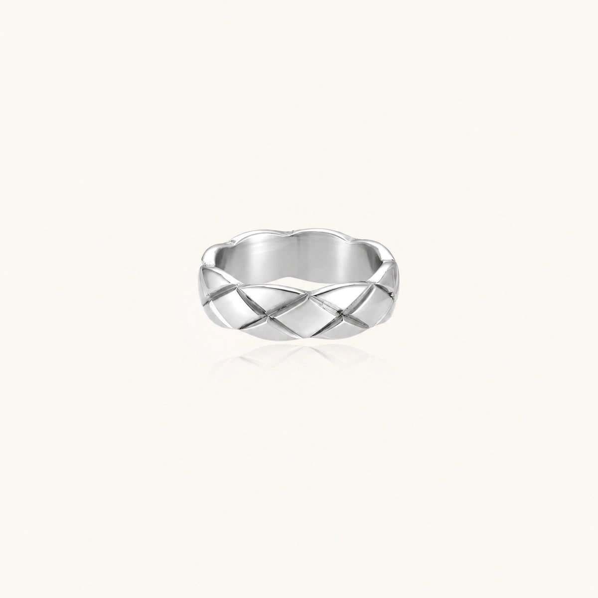Braided stainless steel band ring with geometric interwoven strands in brushed silver finish on white background