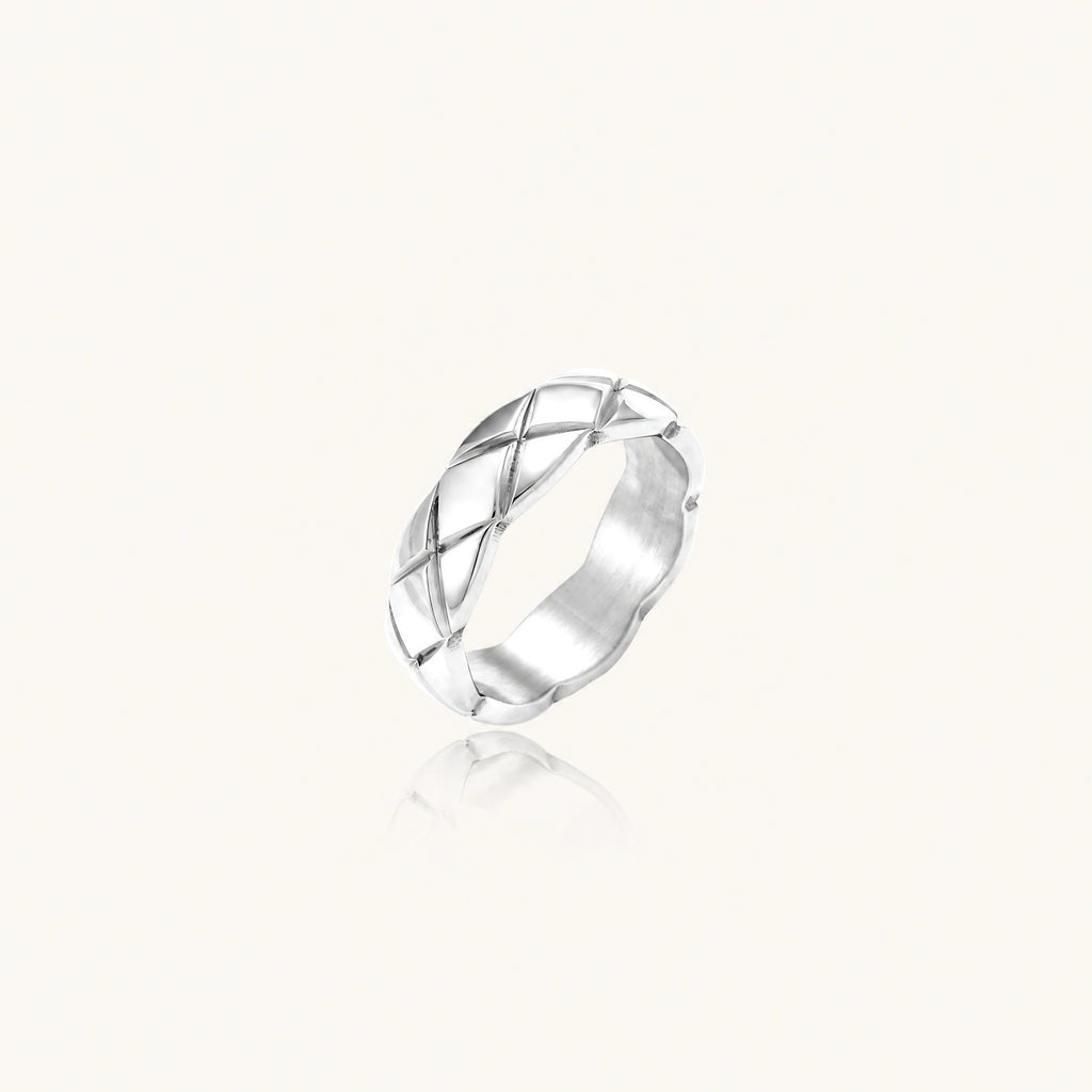 Braided stainless steel band ring with geometric interwoven strands in brushed silver finish on white background
