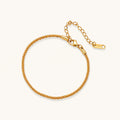 Delicate 18K gold-plated stainless steel bracelet with textured beaded chain on cream background