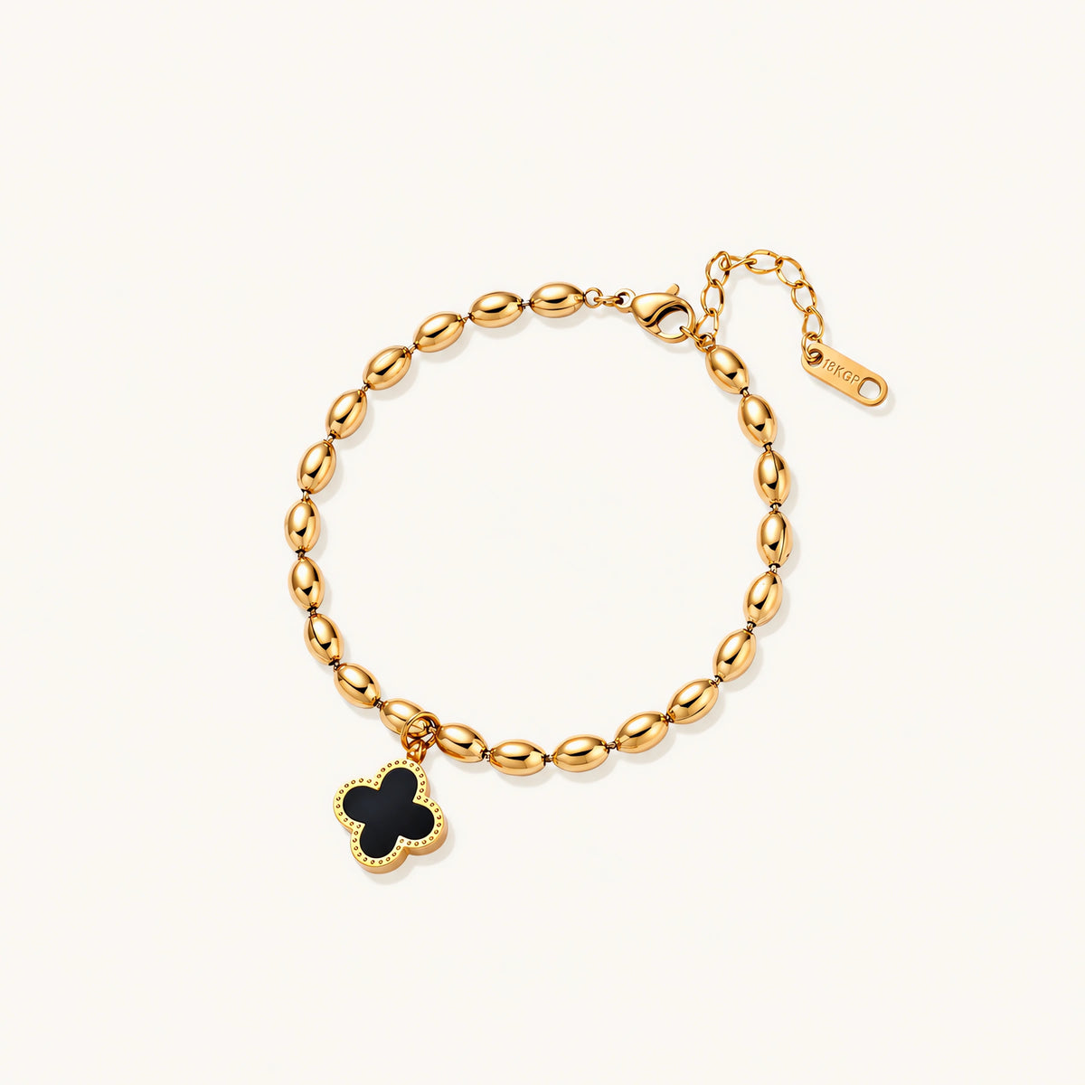 18K gold-plated oval bead bracelet with a four-leaf clover charm in mother-of-pearl or black enamel, adjustable lobster clasp, on white background.