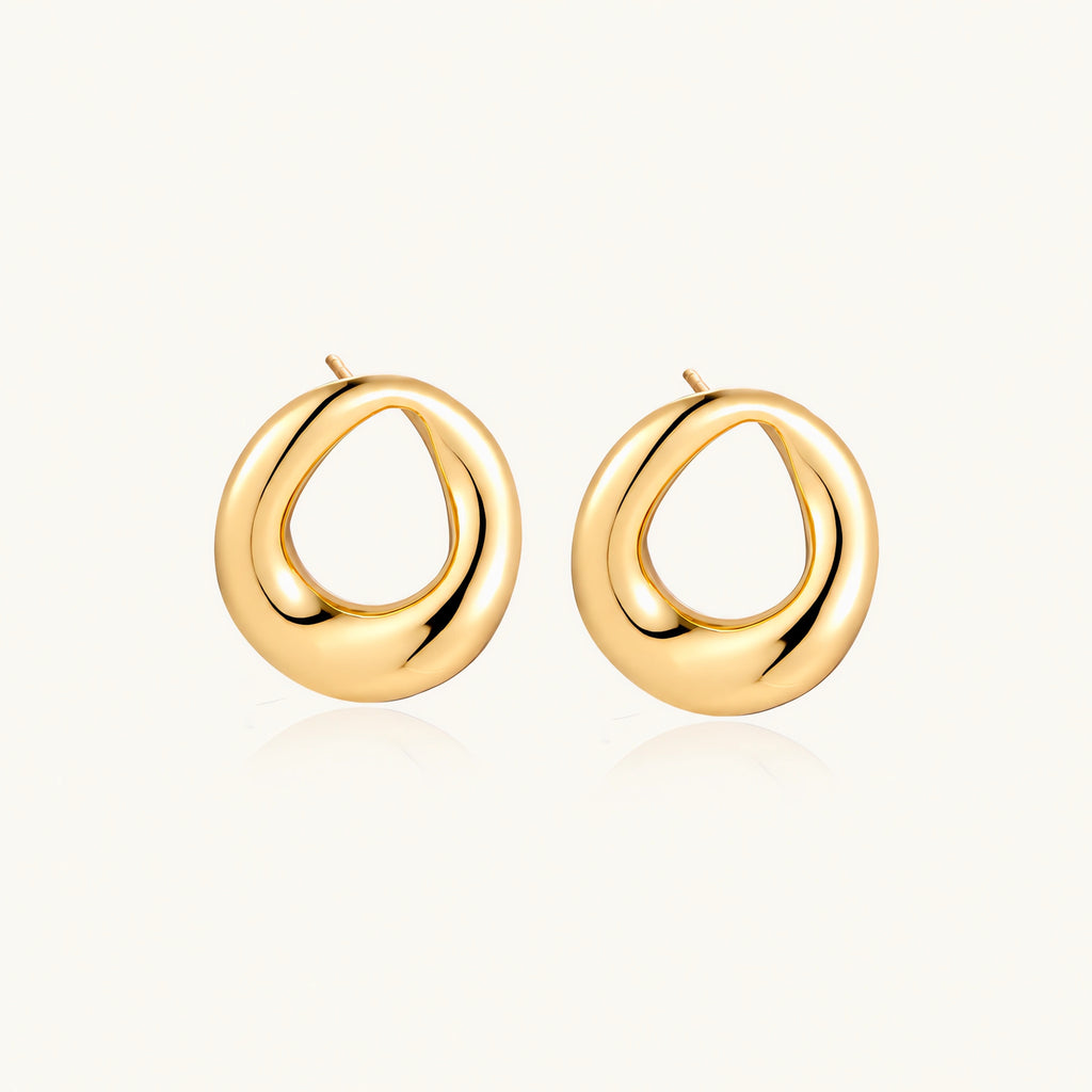 Pair of polished 18K gold-plated stainless steel teardrop earrings with hollow centers on cream background